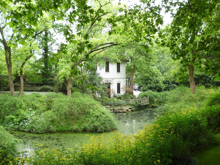 Picturesque white building surrounded by nature at West Lake in Hangzhou, China.